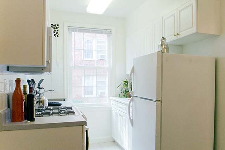 Kitchen with white cabinetry and appliances