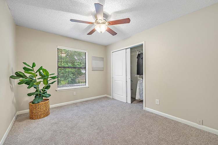 Spacious bedrooms featuring large windows and spacious closets.