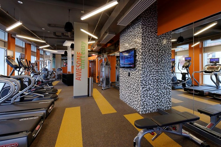 Fitness center with cardio and strength equipment and flat screen TV