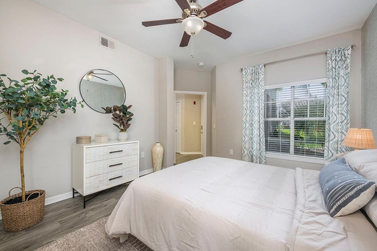 Bedrooms feature wood-style flooring and spacious closets.