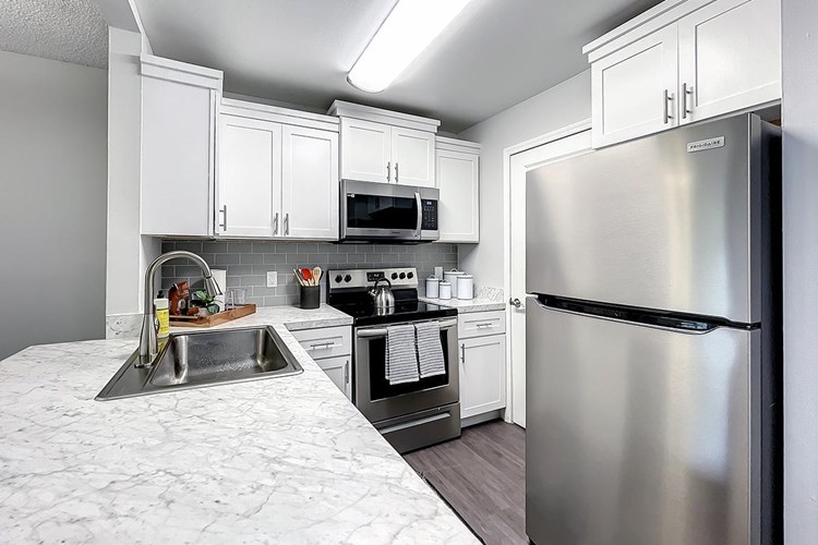 Newly renovated Kitchens feature stainless steel appliances with glass top stoves.