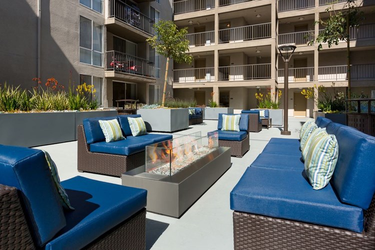 Resident courtyard with barbecue grills, fire pits, and lounge seating