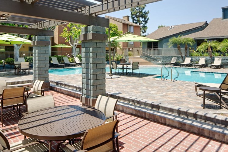 Swimming pool and sundeck with picnic tables