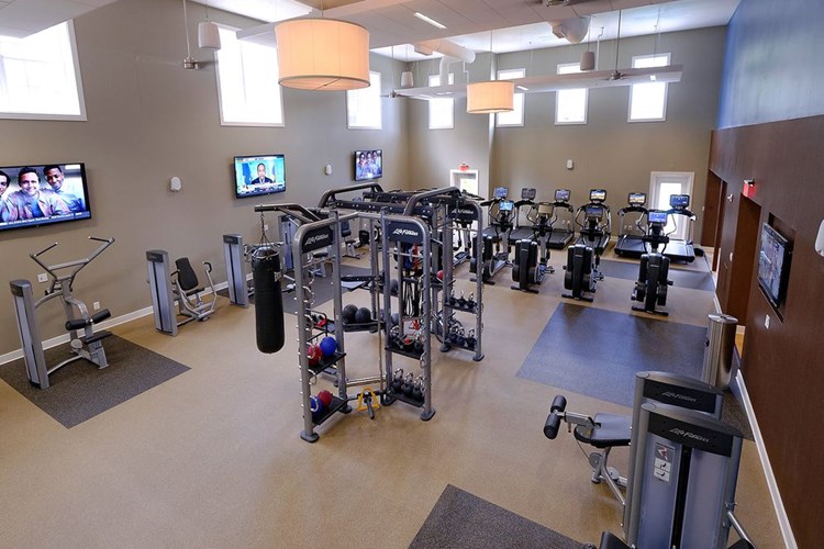 Fitness center with strength training equipment, cardio equipment and flatscreen televisions