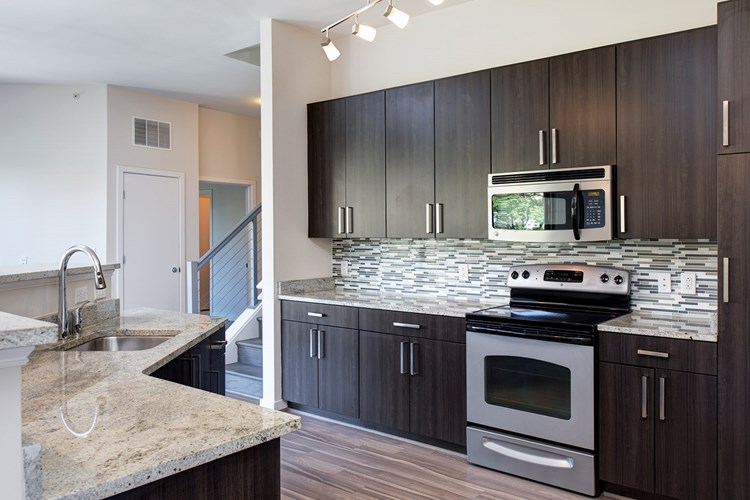 Modern kitchens with granite countertops, stainless steel appliances, and tile backsplash