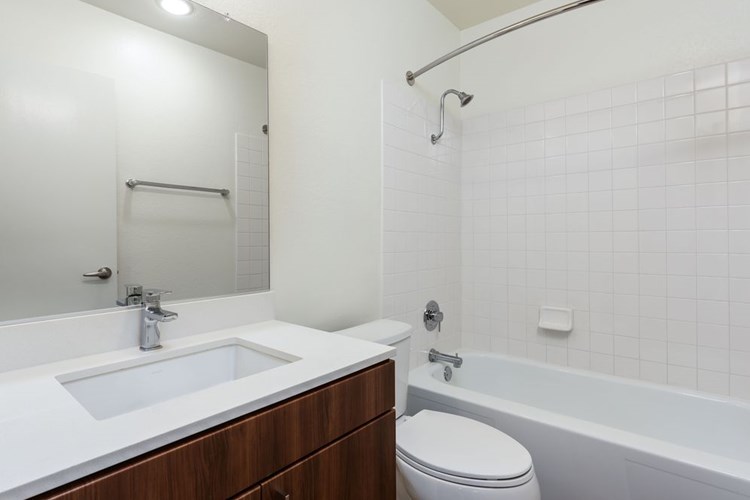 Renovated I bath with new cabinetry, quartz countertop, and hard surface flooring