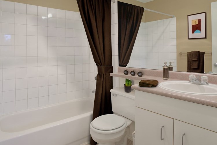 Classic Package I bath with laminate countertops, white cabinetry, and laminate flooring