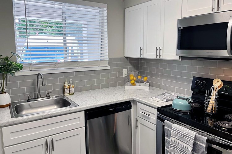 Modern updates with white countertops and subway tile available
