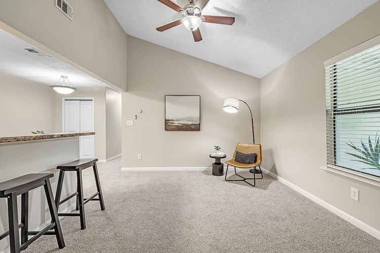 Spacious, open living rooms featuring plush carpeting, vaulted ceilings and a multi-speed ceiling fan. 