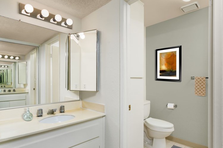 Classic Package bath with white laminate countertops and white cabinetry