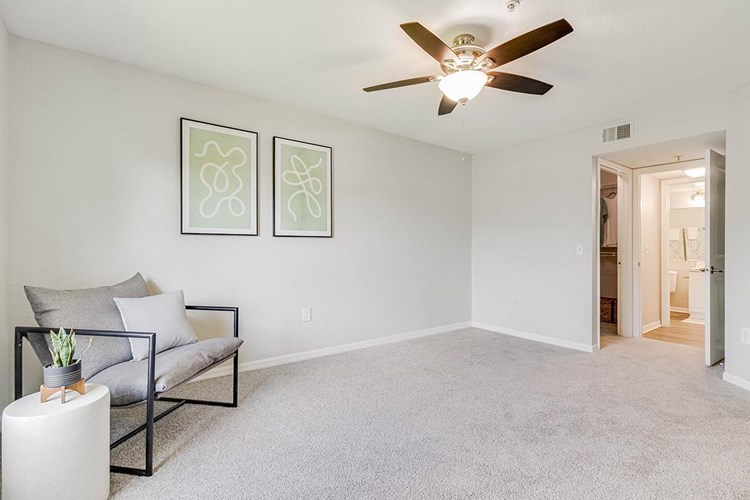 Spacious bedrooms featuring plush carpeting, closets with organizers, and multi-speed ceiling fans.