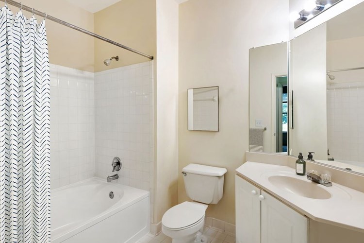 Classic Package I bath with white cabinetry, white laminate countertops, and hard surface flooring
