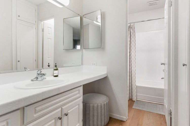 Classic Package II bath with white tile countertop, white cabinetry, and hard surface flooring