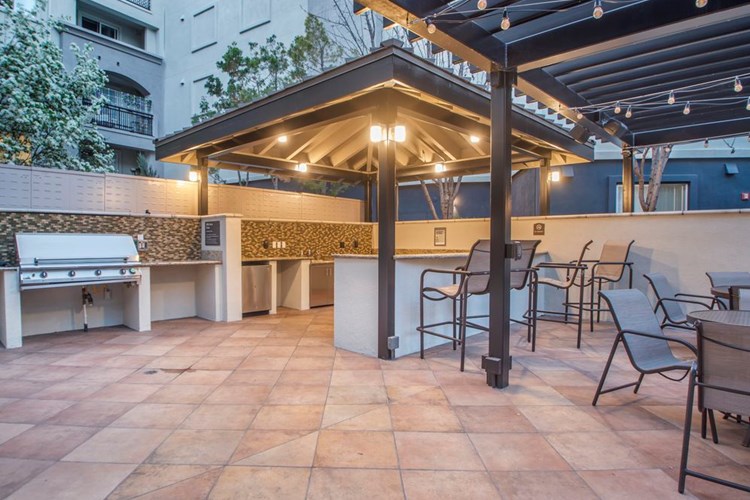 Outdoor kitchen with barbeque grills and picnic seating