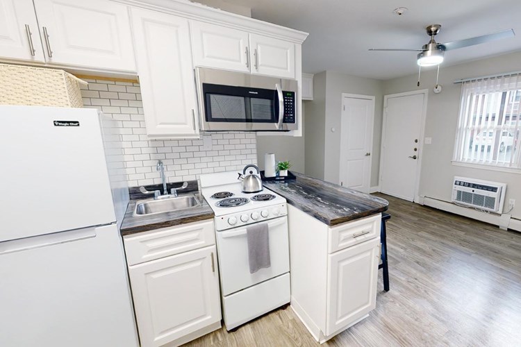 Your new kitchen has plenty of cabinet space and a breakfast bar.