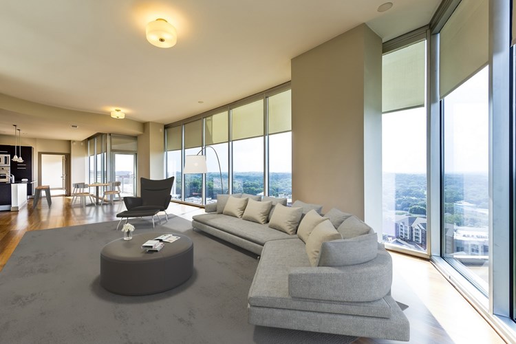 Spacious living room features floor-to-ceiling windows with amazing views of Buckhead