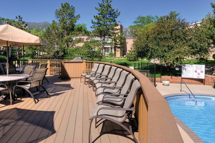 Large poolside sundeck with lounge chairs  