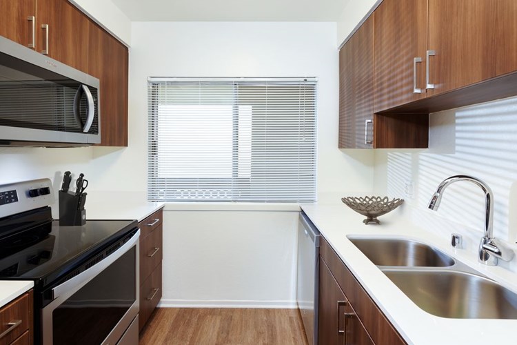 Renovated I kitchen with new cabinetry, quartz countertops, stainless steel appliances, and hard surface flooring