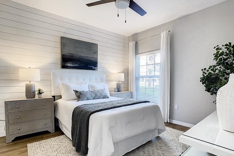 Spacious bedrooms featuring large windows and plush, neutral carpeting, and ample closet space. 