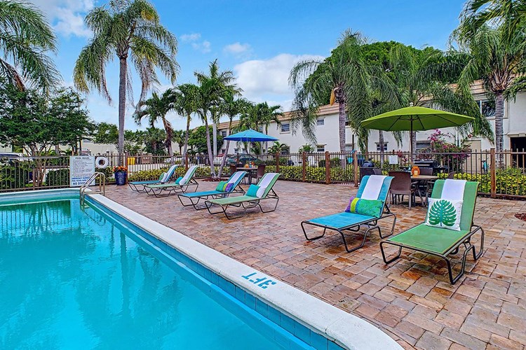 Our sundeck features plenty of poolside loungers and tables.