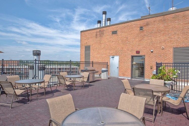 Rooftop dining areas with barbecue grills and seating