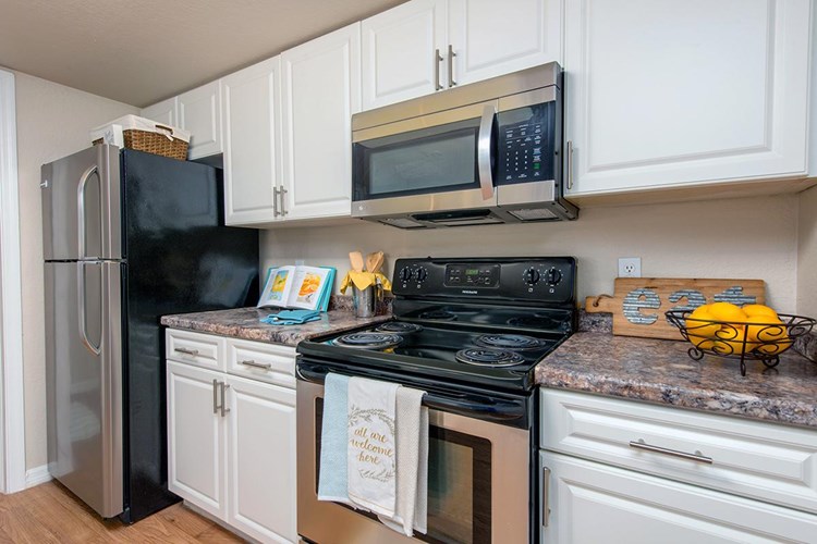 Kitchens feature stainless steel appliances.