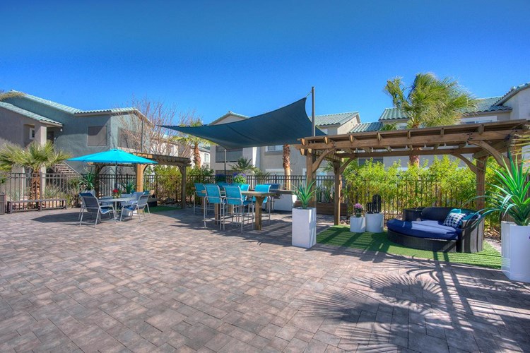 Enjoy a nice sunny day from our expansive sundeck featuring loungers, a pergola, and an outdoor kitchen.