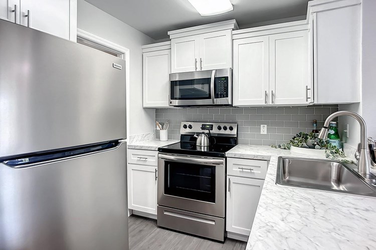 Premium kitchens with shaker cabinetry, plank flooring and new appliances.