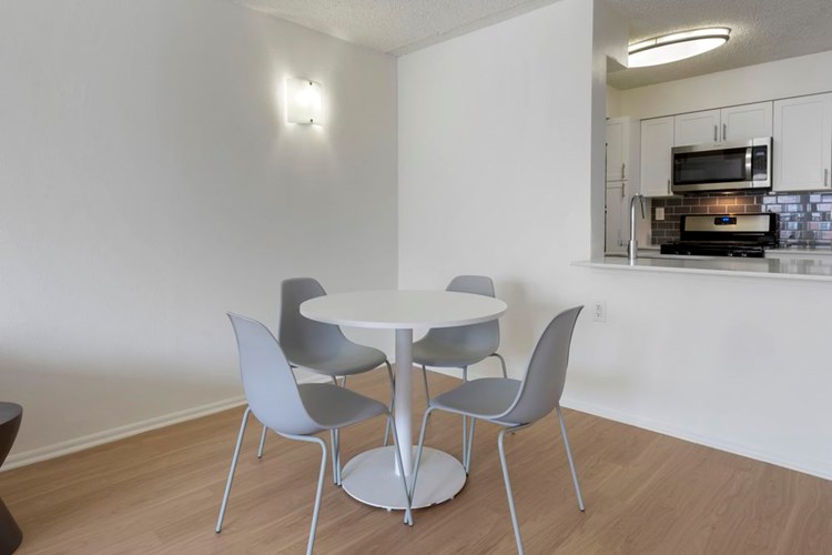 Furnished+ apartment homes include a dining set (Representative Image – exact items and style of furnishings may vary)