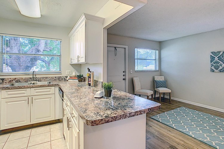 Kitchens feature a breakfast bar overlooking the living room area.