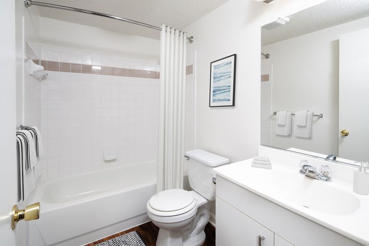 Classic Package I Bath with white cabinetry, white laminate countertops, and hard surface flooring