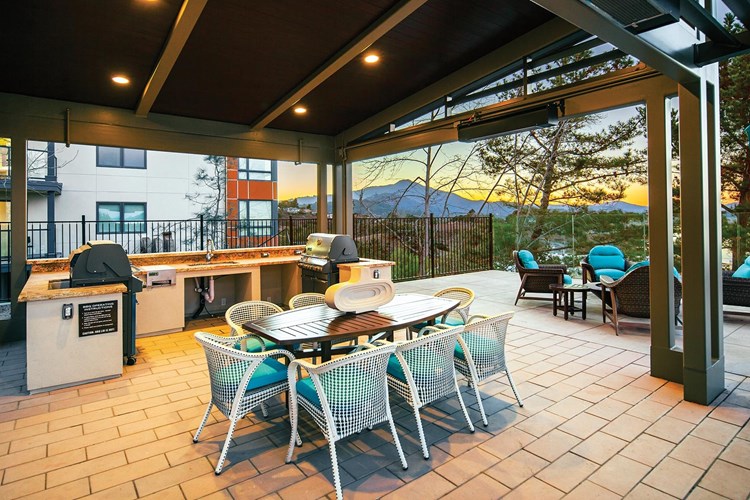 Socialize with friends at our covered outdoor barbecue area with two grills and a sink