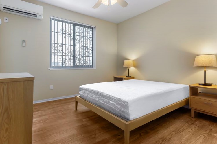 Furnished+ apartment homes feature queen bed with mattress, dresser, nightstands, and lamps (Representative Image – exact items and style of furnishings may vary)