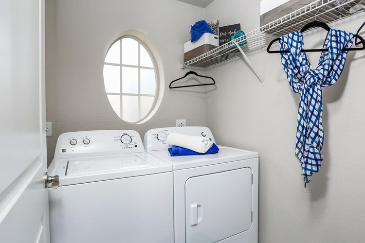 Laundry rooms featuring full size washer and dryers for your convenience. 