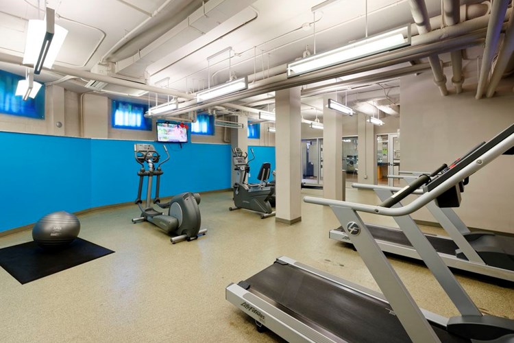 Fitness center with cardio equipment and flat screen televisions