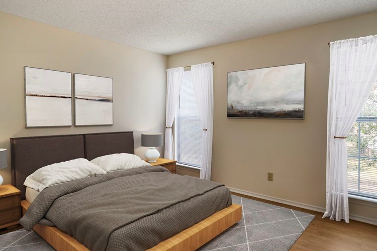 Renovated Package I bedroom featuring hard surface flooring in select units