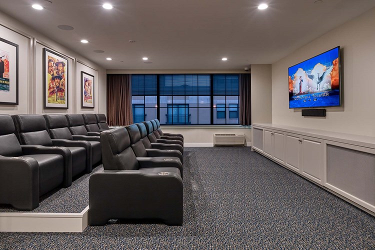 Theatre room with large screen TV and stadium seating