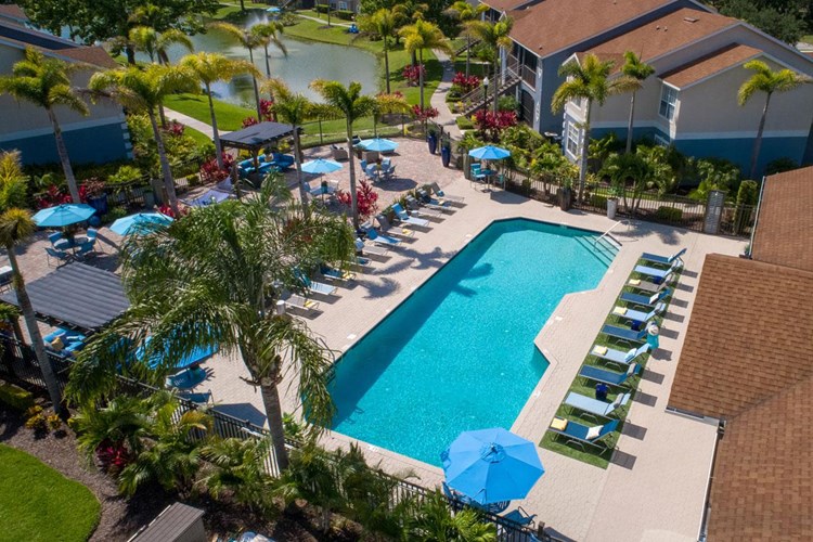 Our expansive sundeck/pool area includes plenty of loungers, tables with umbrellas, and other seating. 