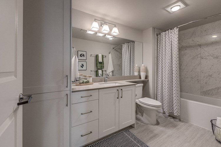 Our beautiful bathrooms have inset sinks on quartz countertops, and ample storage including a linen closet. 