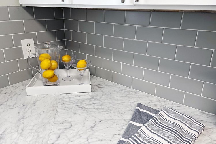 Kitchens feature a subway style backsplash. (In select units)