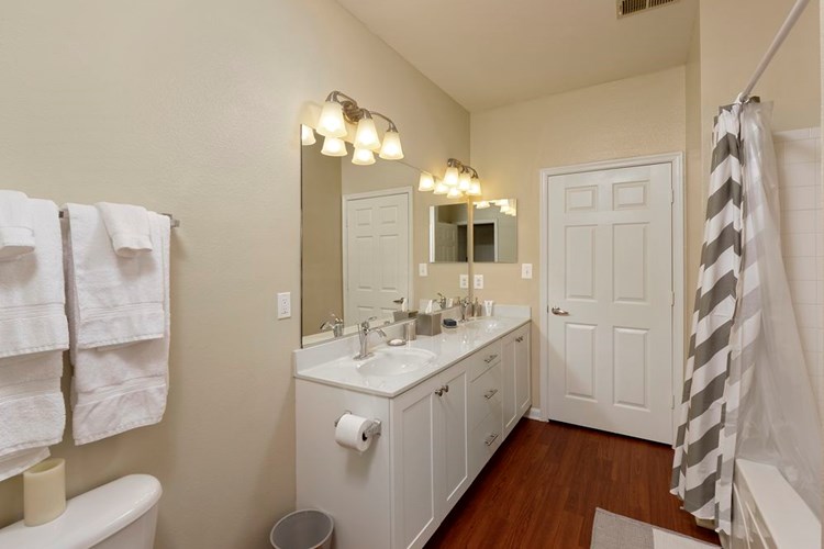 Classic Finish Package dual vanity bath with white cabinetry and hard surface flooring