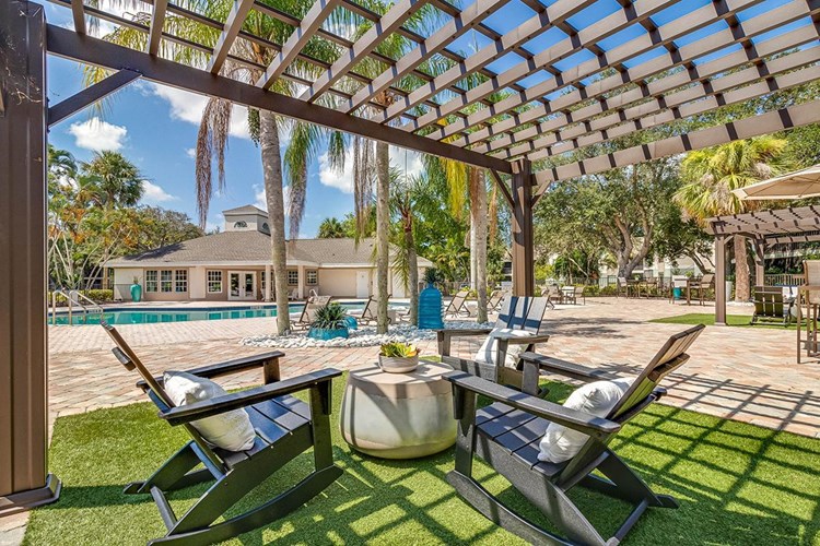 Relax in the shade under one of our poolside pergolas.