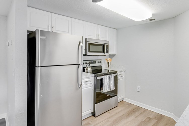 All kitchens feature sleek, stainless-steel appliances, including a dishwasher.