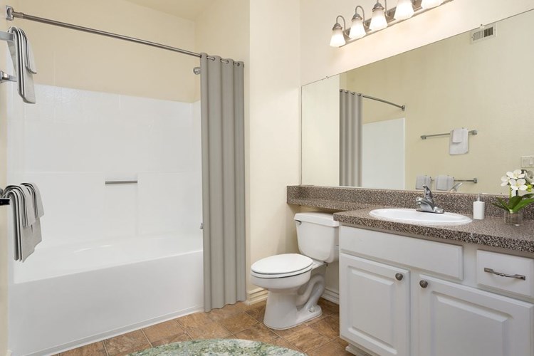 Classic Package I bath with faux granite countertop, white shaker cabinetry, and hard surface flooring