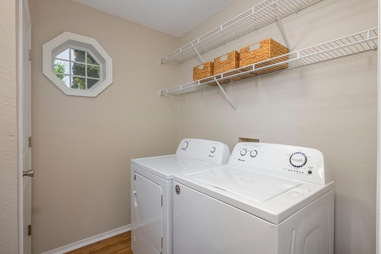 Laundry room with full size washer and dryer included.