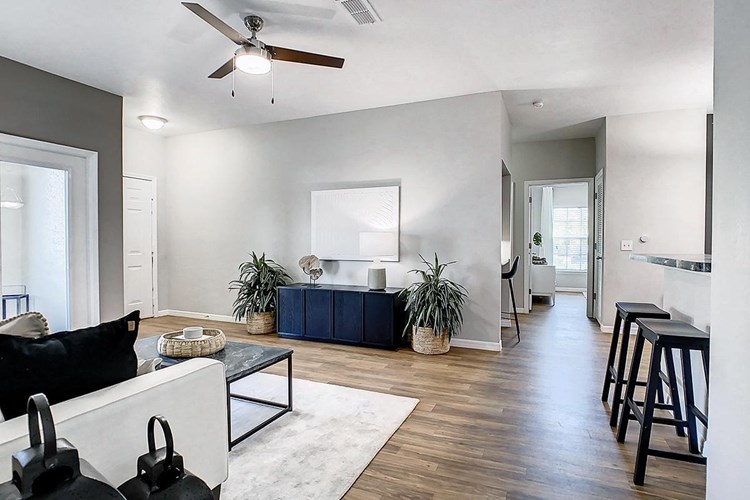 You'll love our open floor plan concepts including spacious living rooms with wood-style flooring and a ceiling fan.