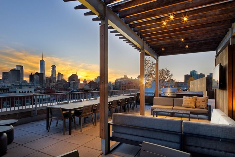 Rooftop terrace with lounge seating and grilling stations