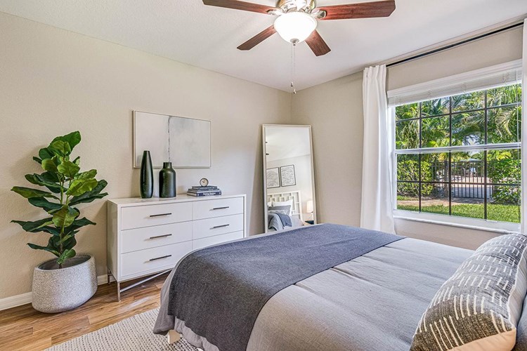 Bedrooms feature multi-speed ceiling fans and wood-style flooring.