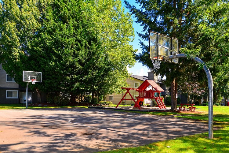 The Reserve at Bucklin Hill exterior with field closer picture of basket ball court and playground