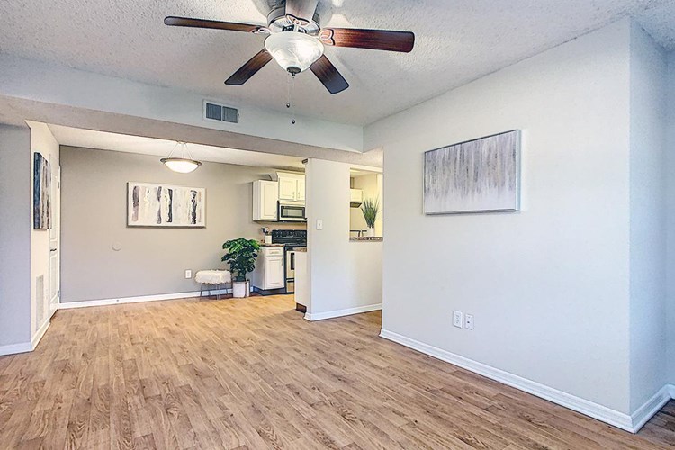 Spacious open floor plans featuring wood-style flooring and multi-speed ceiling fans.